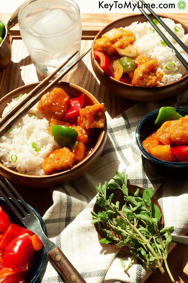 A side view of sweet and sour chicken in shallow bowls.