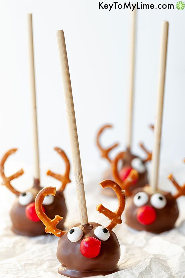 Reindeer cake pops on a sheet of parchment paper.