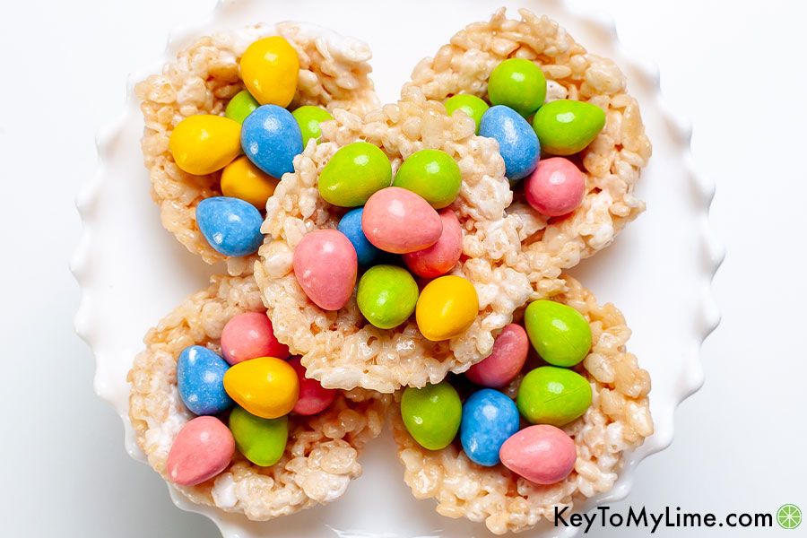 Rice Krispie nests with pink, green, blue, and yellow candy eggs.