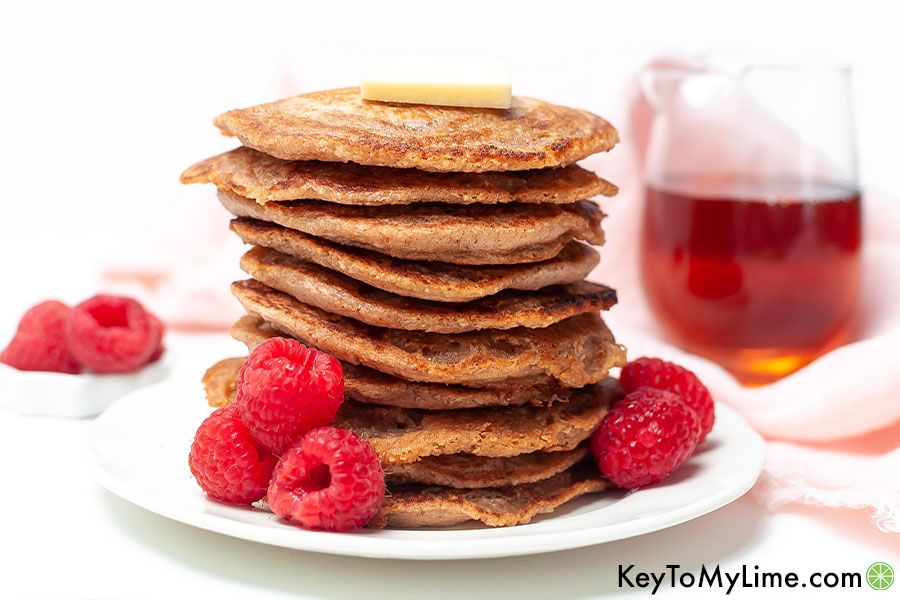 Oat flour pancakes next to fresh raspberries.