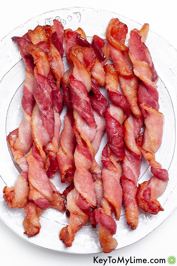 Twisted bacon on a white plate.