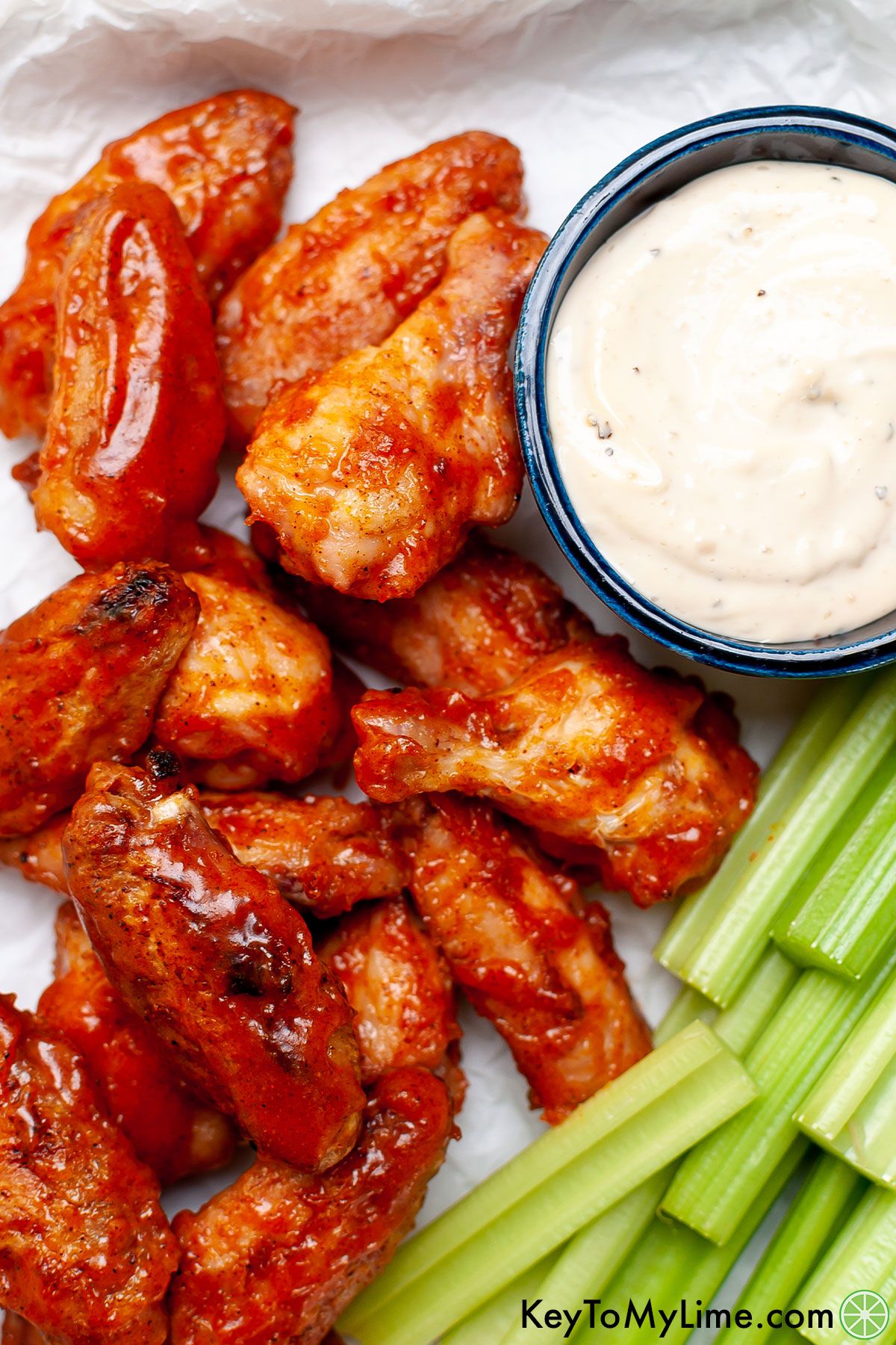 Grilled sticky wings next to celery.