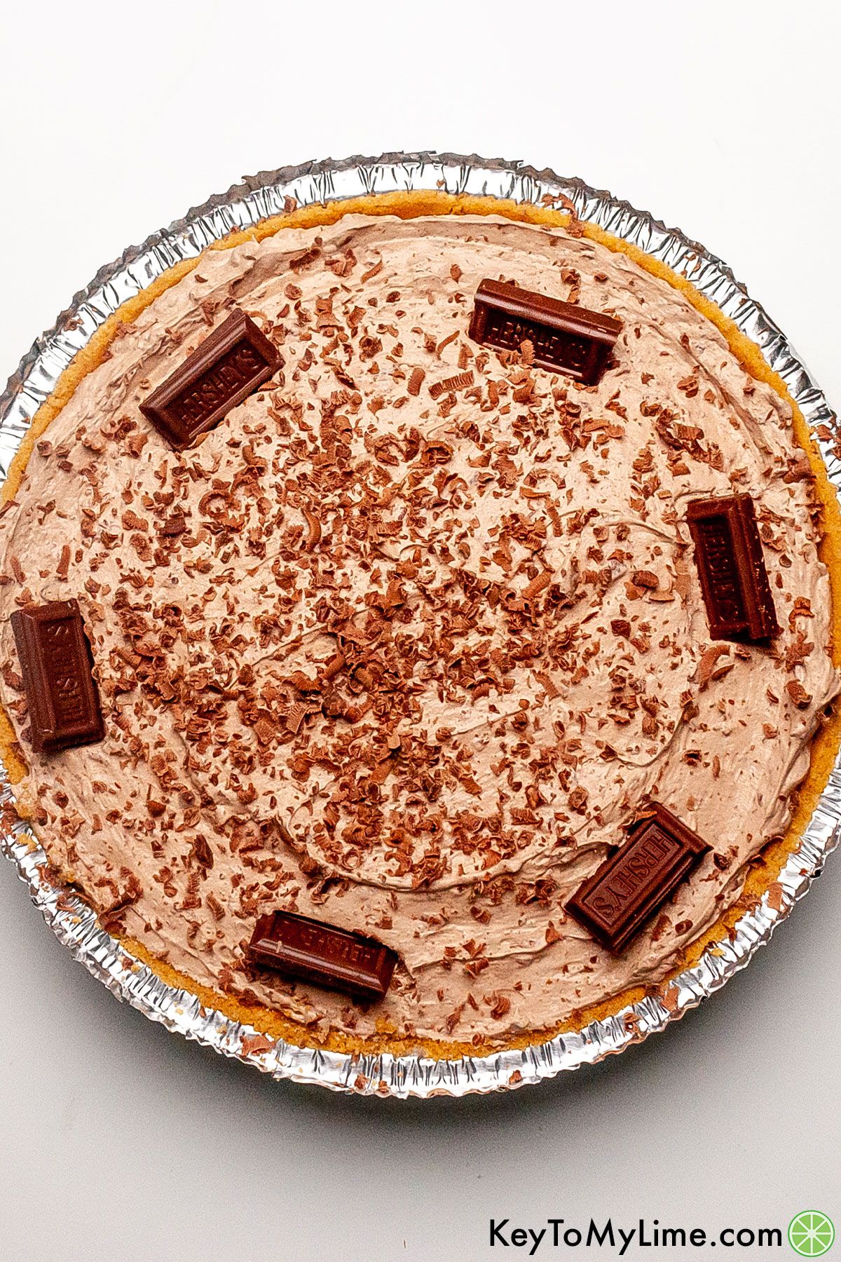An overhead image of Hershey pie garnished with chocolate squares and shaved chocolate.