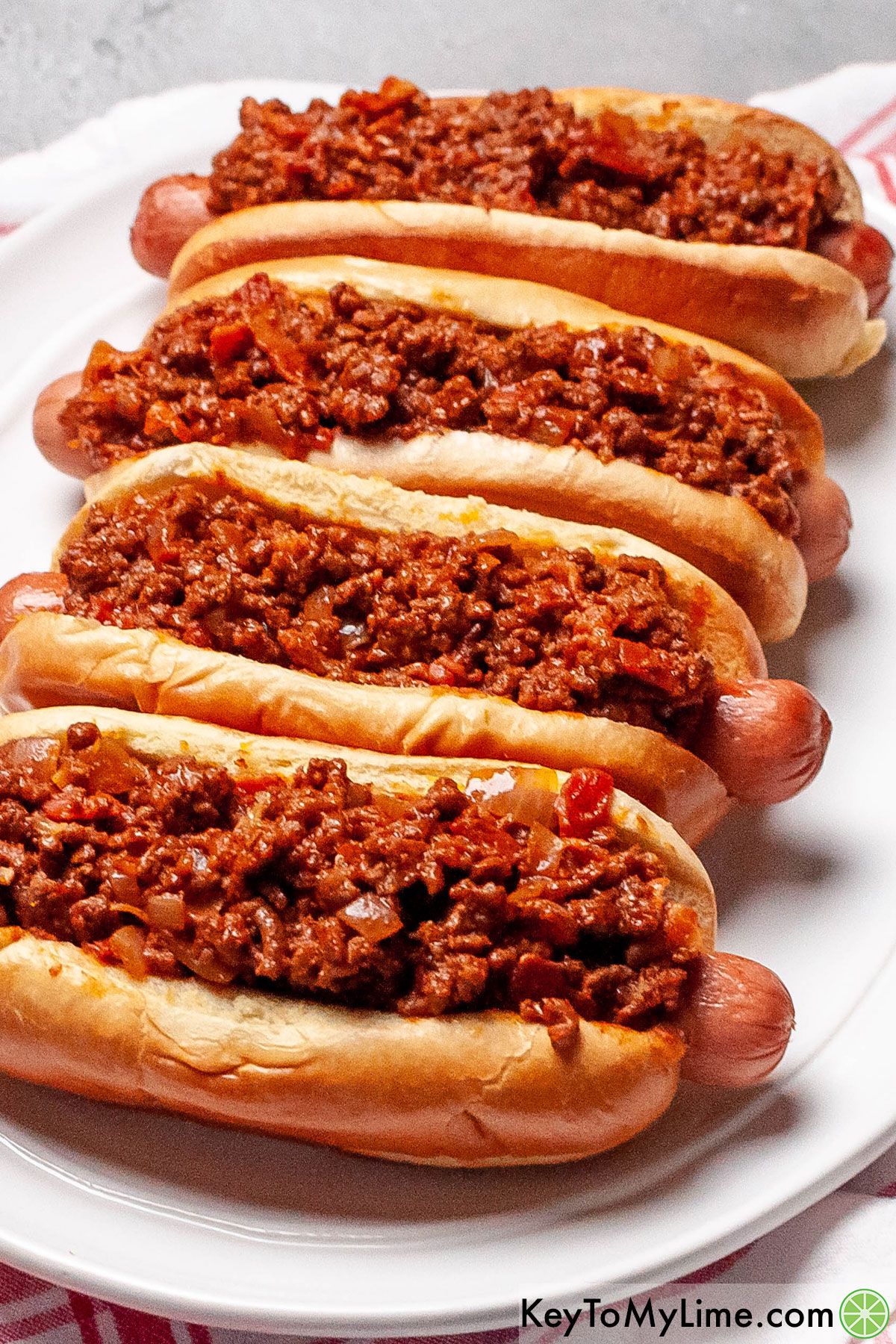 The best hot dog chili on top of hot dogs.