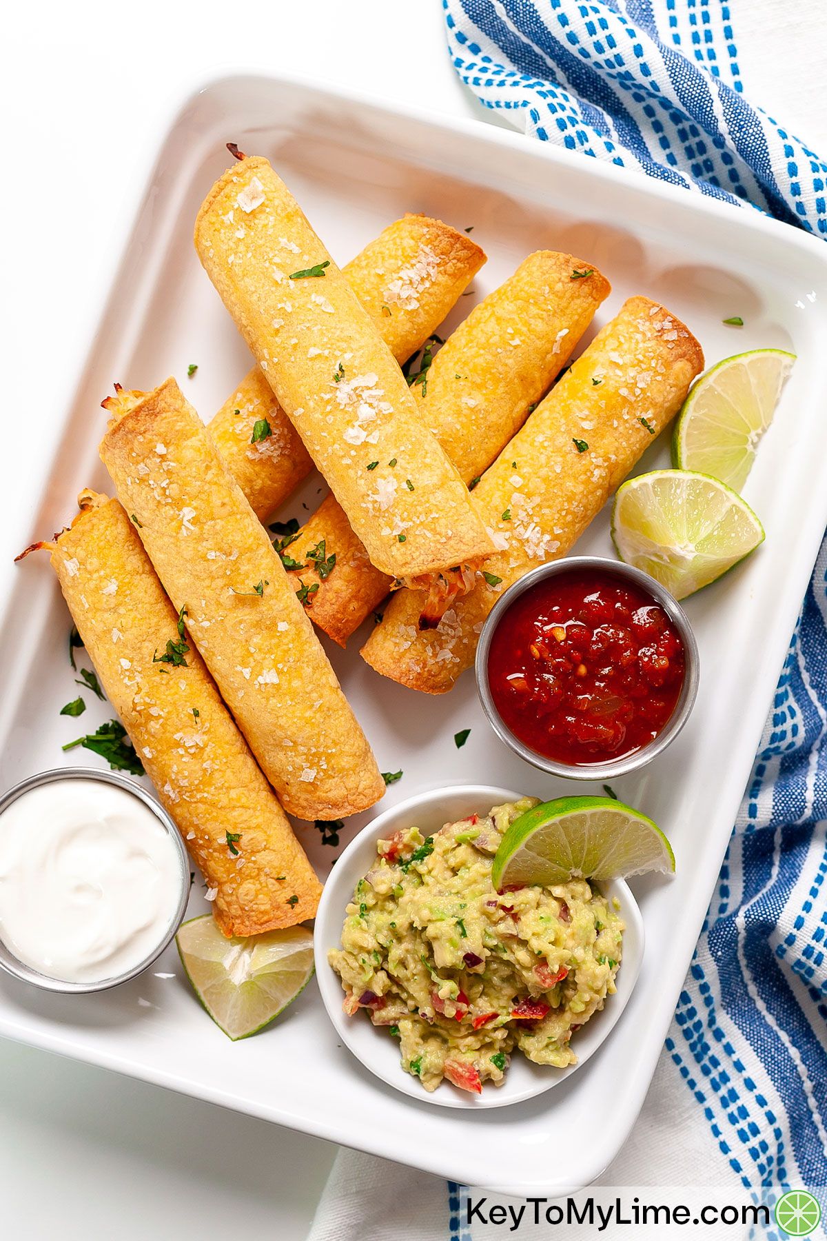 Chicken taquitos with salsa, guacamole, and sour cream.