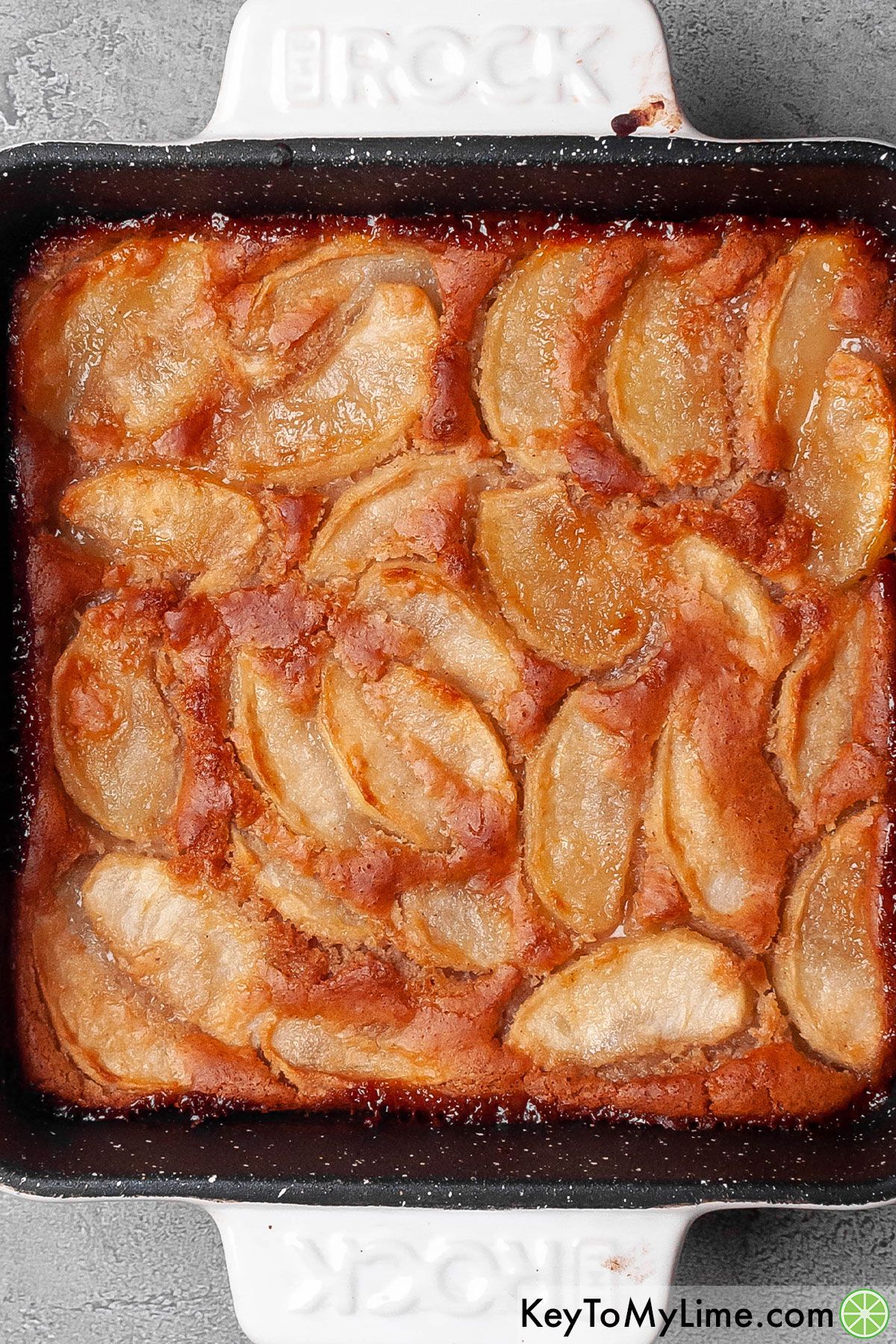 Freshly baking Bisquick apple cobbler with fresh apple slices.
