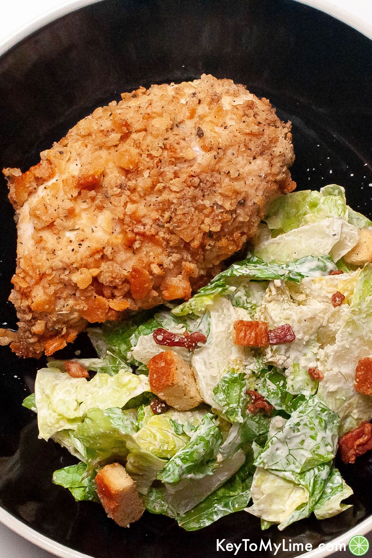 Crispy Ritz cracker chicken next to a salad.