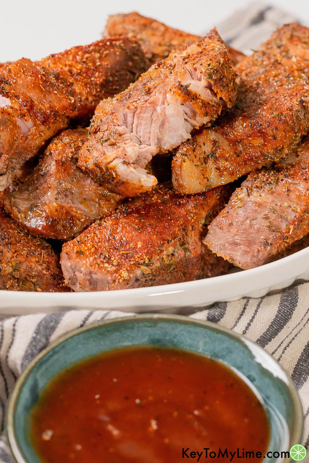 A close up image of tender fall apart boneless pork ribs baked in the oven.