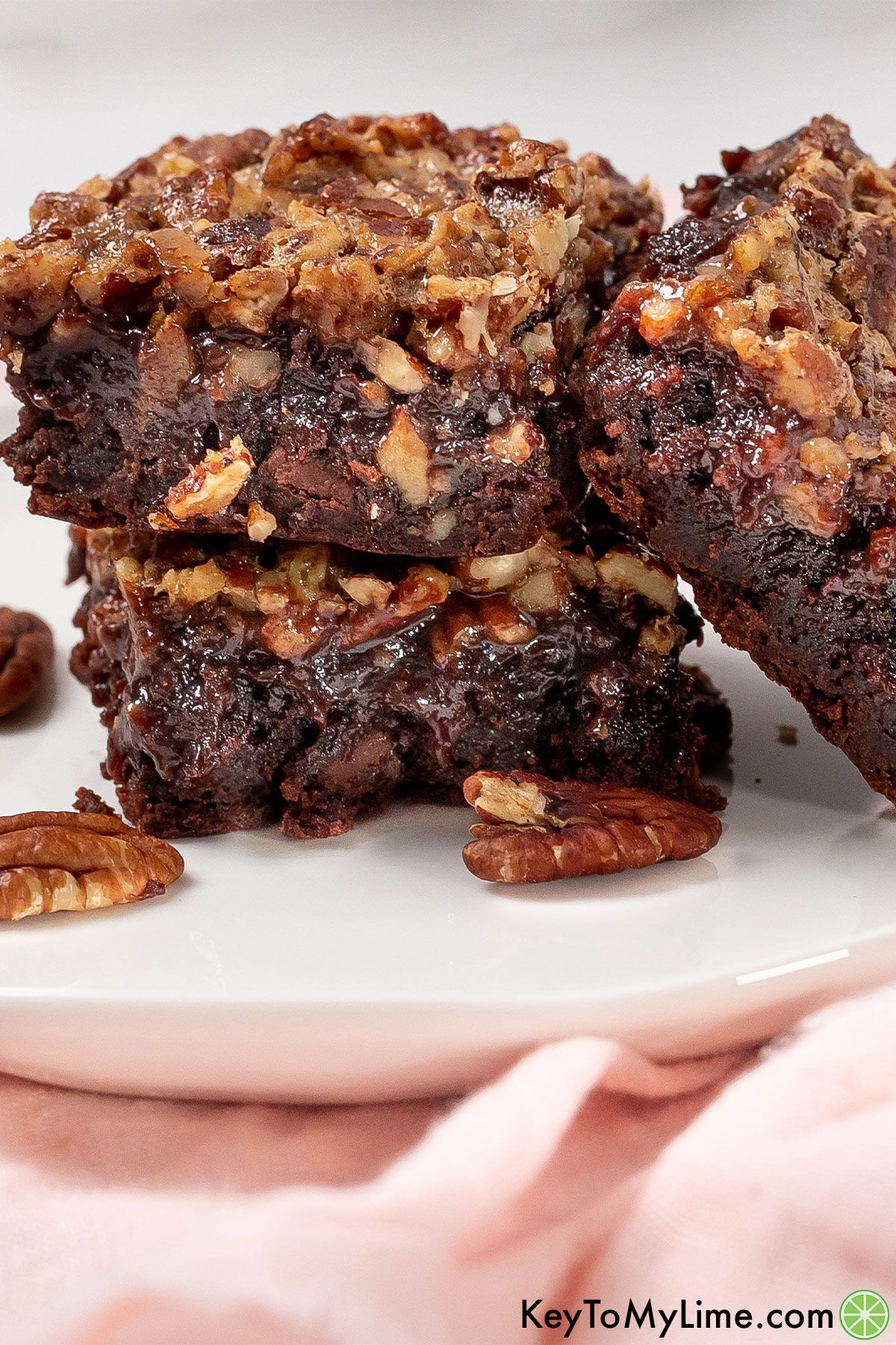 A close up image of a stack of pecan pie brownies.