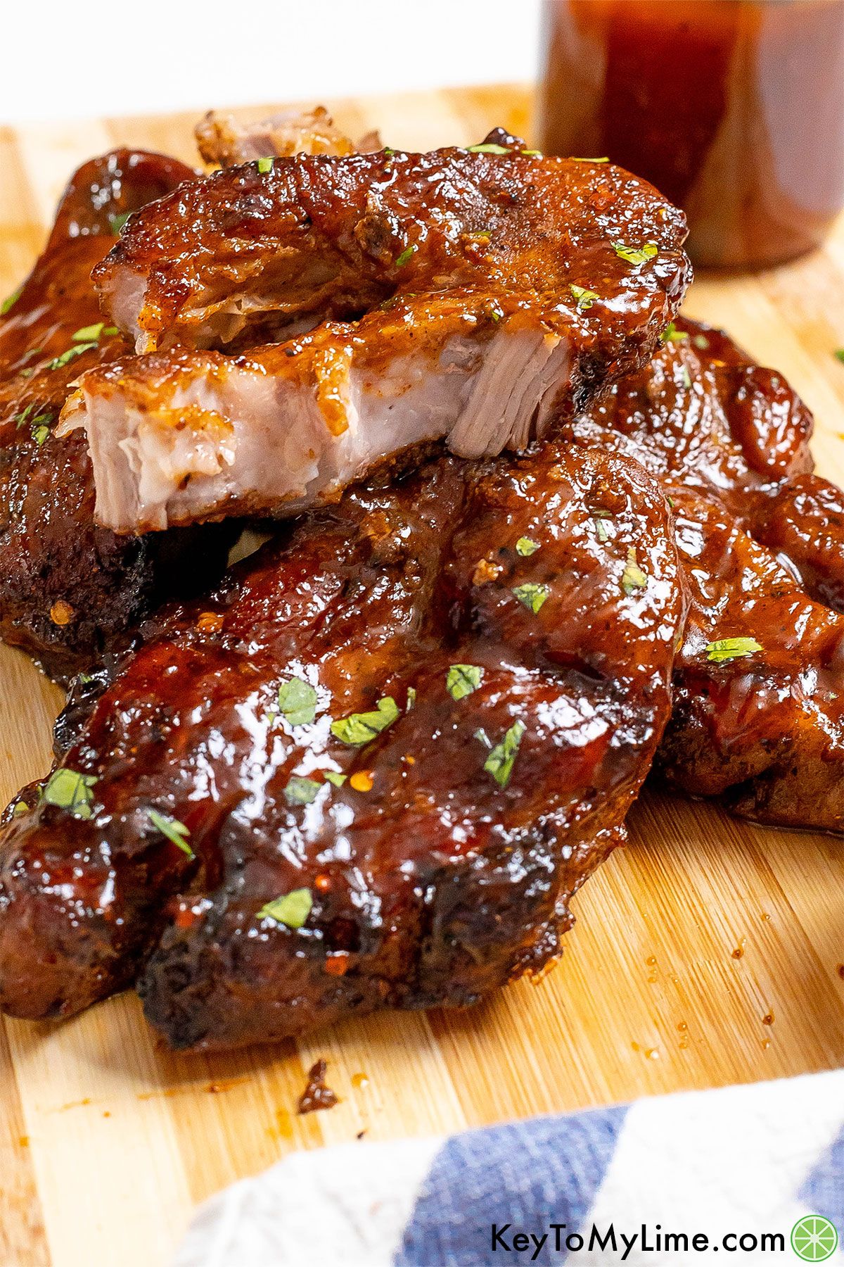A pile of country style ribs with one pulled apart to show the tender texture.