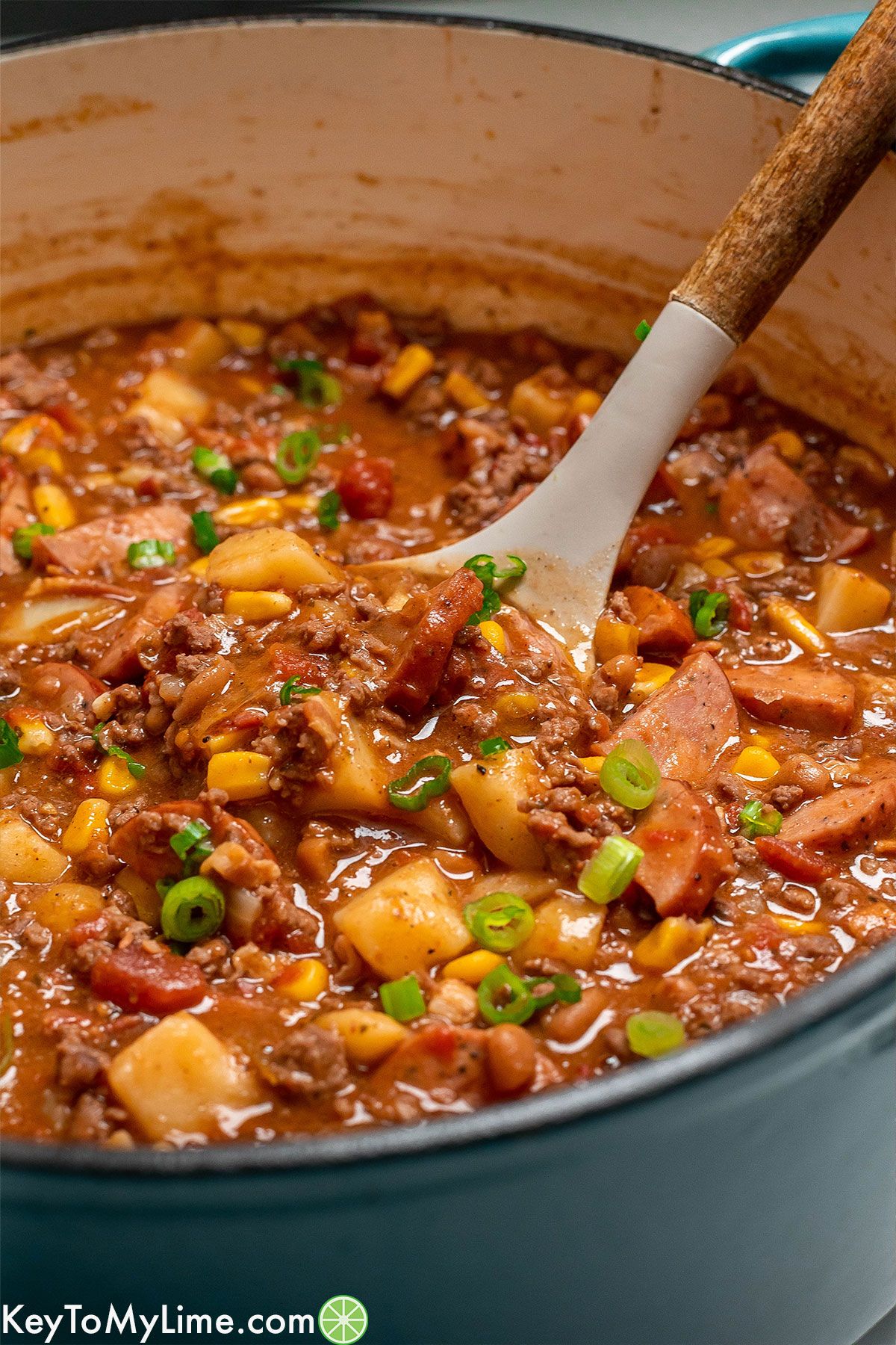 A close up shot of cowboy stew on a serving spoon.