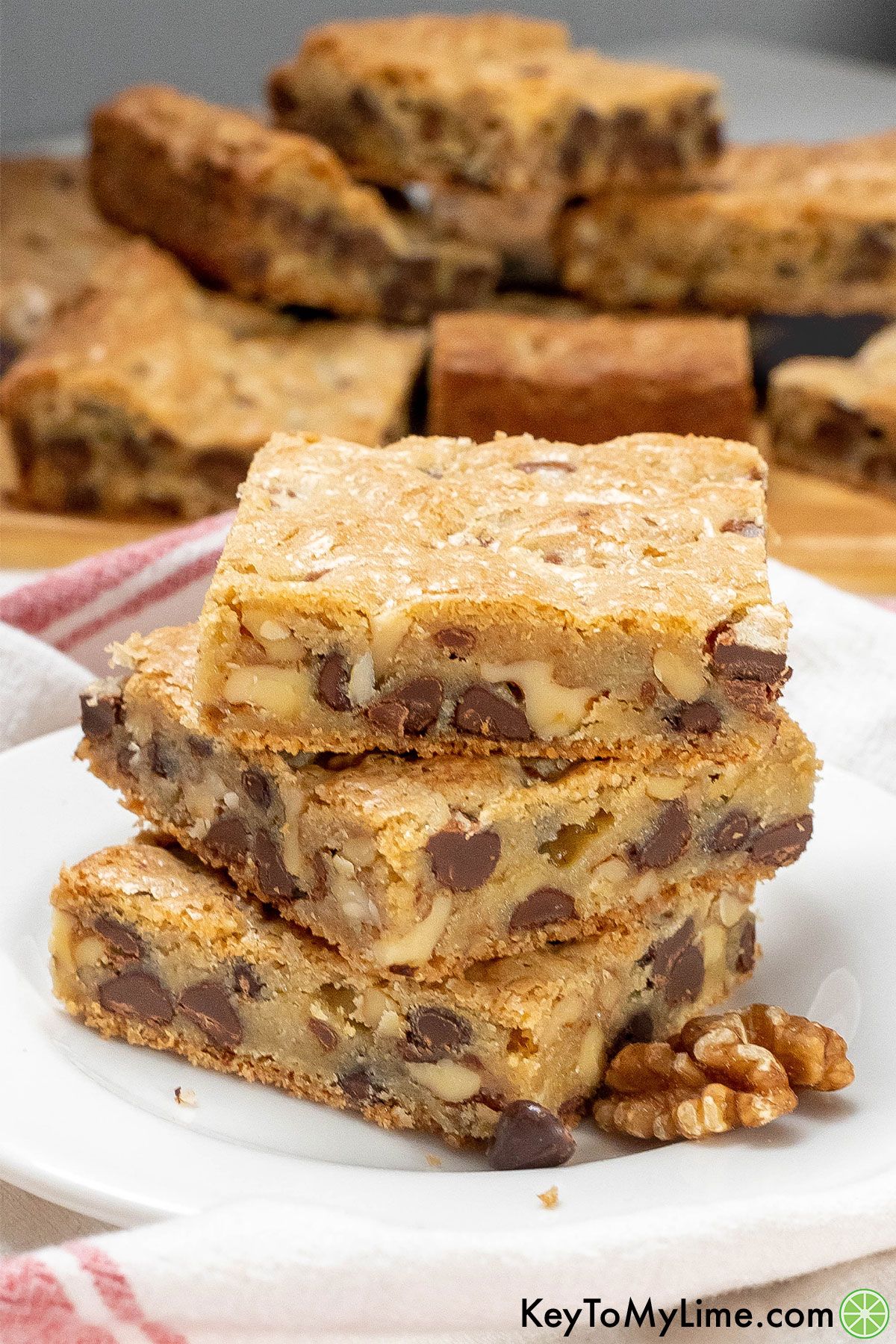 A stack of freshly cut cookie bars on a white plate.