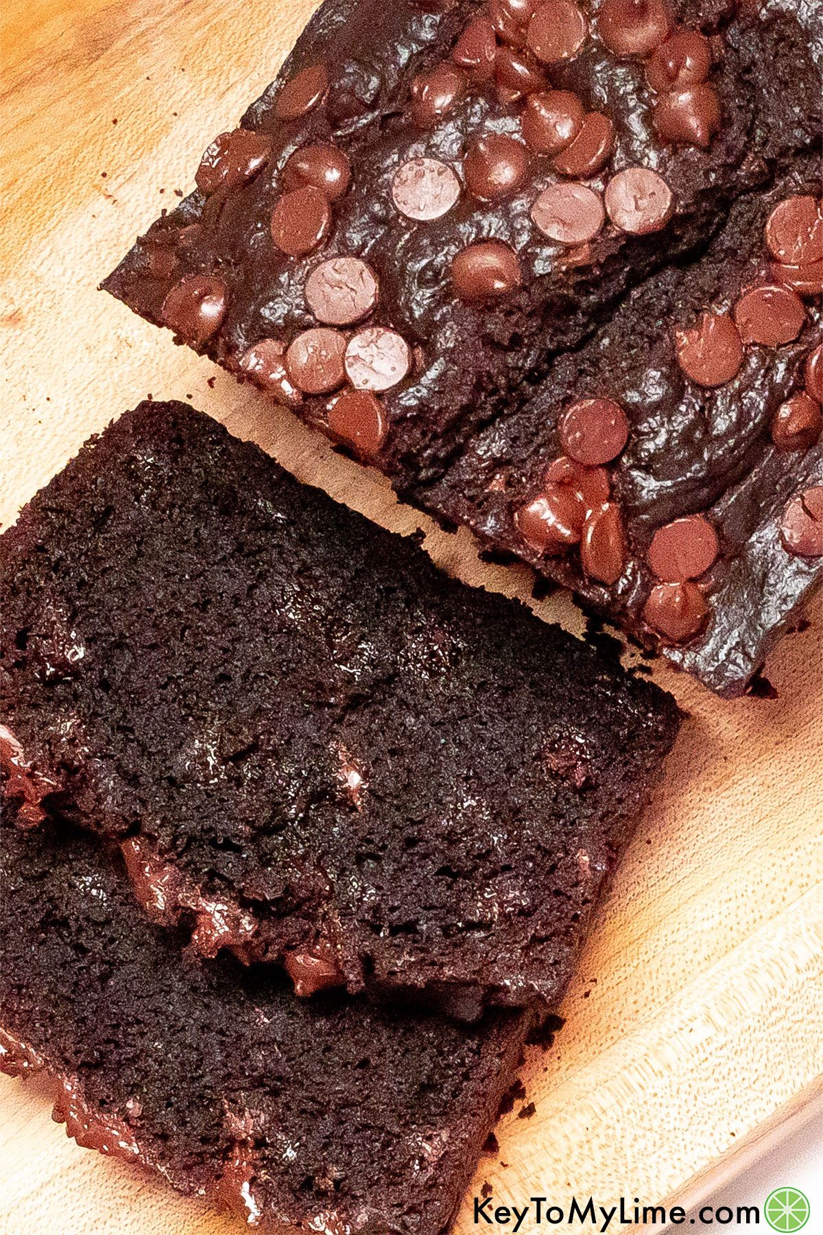 A zoomed in image of slices of chocolate bread showing the moist interior texture with melted chocolate chips.