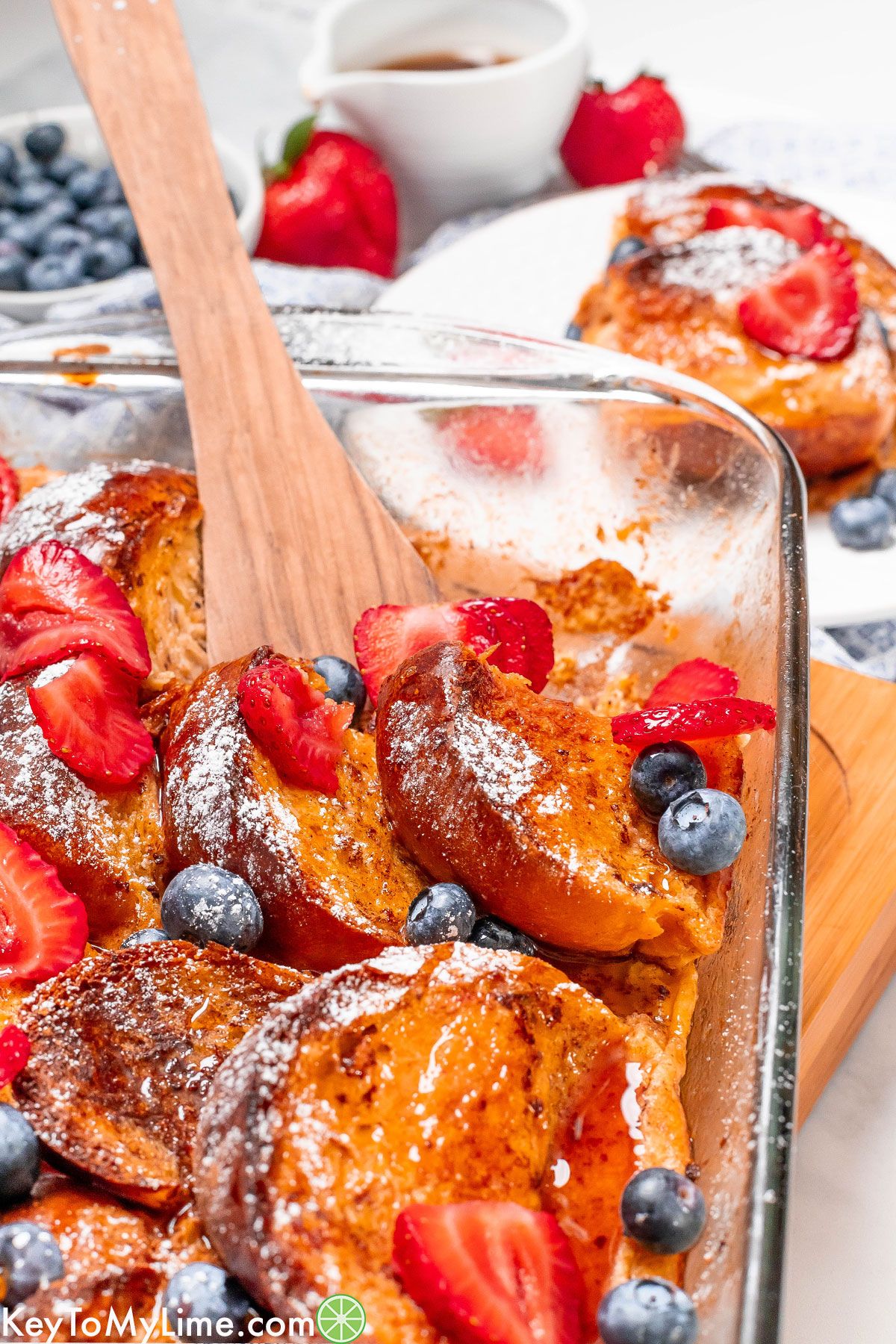 A close up image of a fully baked and garnished French toast bake showing the golden texture.
